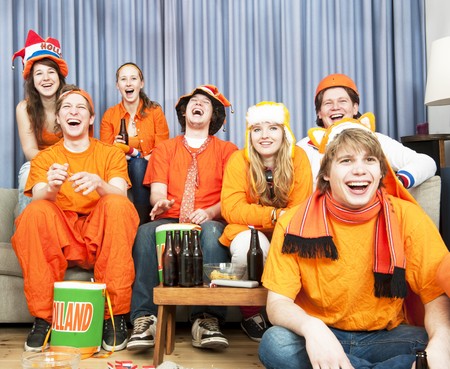 Soccer fans laughing at what's happening during a game of their national teamの写真素材