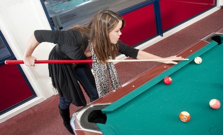 Young woman playing poolの写真素材