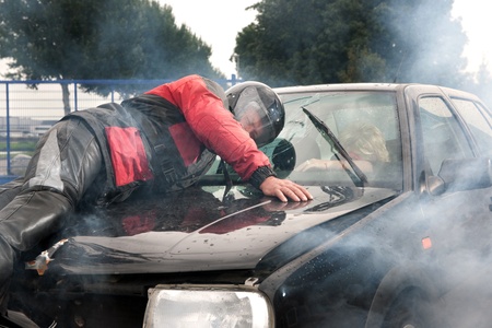 An accident between a motorcycle and a carの写真素材