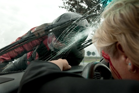 Frontal hit between a car and motorcycle as viewed from inside the carの写真素材