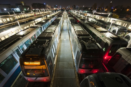 Deserted train depot with a city skyline at night