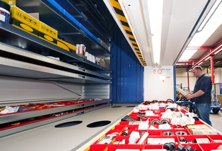 Mechanic entering the tray number of a automated storage shelfsの写真素材