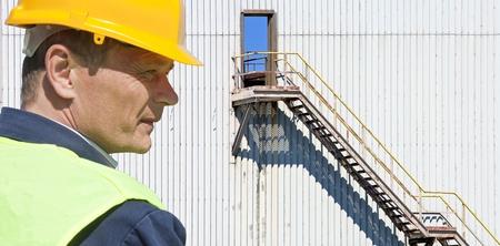 Portrait of an Industrial supervisor in front of an old factoryの写真素材