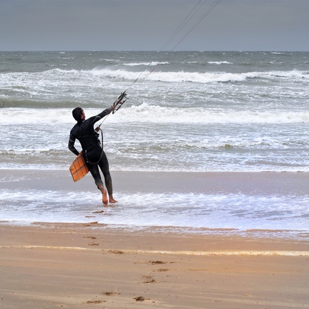 Kite surfer heading out to sea on a stormy dayの写真素材