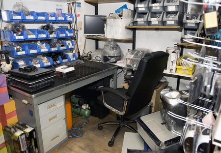 Cluttered and untidy computer room of a computer repair shop