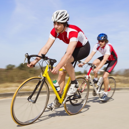 Two cyclists sprinting past the camera at high speedの写真素材