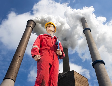 Engineer looking up towards the wind direction with tall smoke stacks, emitting vaporized water, seen from belowの写真素材