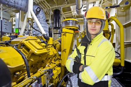 Mechanical engineer posing in the engine room of an offshore supply vesselの写真素材