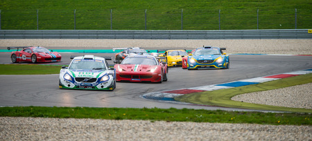 ASSEN, NETHERLANDS - OCTOBER 19, 2014: Competitors in the supercar challenge following eachother through a chicane on TT Circuit Assenのeditorial素材