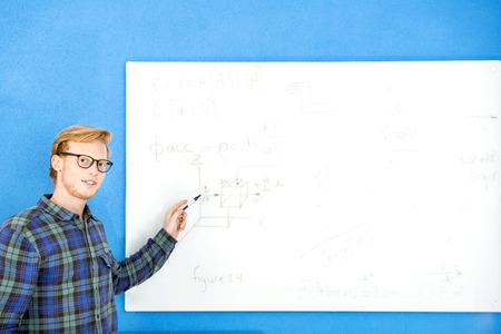 Portrait of confident male designer explaining plan on paper at creative officeの写真素材