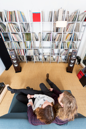 top view shot of a couple listening to music on the sofaの写真素材
