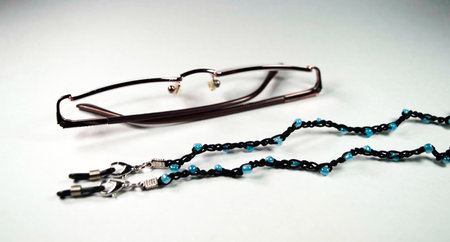 Glasses chain made with black thread and blue beads.の写真素材