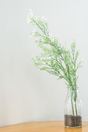 a vase of flolwers on the wooden tableの写真素材