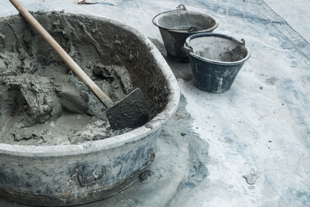 mixed cement in the container with the tool prepared for buildingの写真素材