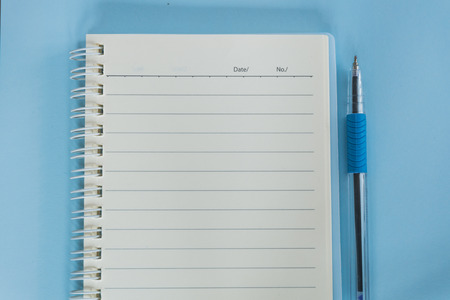 blue notebook and penの写真素材