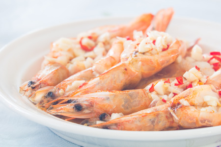 cooked prawn with the chopped chili and garlic on topの写真素材
