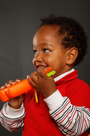 A cute little boy smiling and play with plastic keysの写真素材