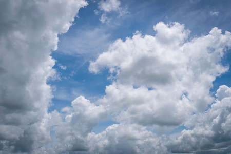 The blue sky with moving white clouds. The most of clouds are beautiful color and shade, suitable for use as background image.の写真素材