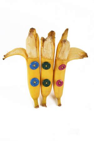 opened bananas standing with buttons on bodyの写真素材