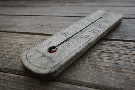 wood thermometer on old wood background