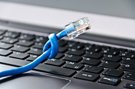 Network cable with knot on computer keyboardの写真素材
