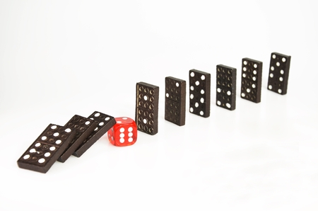 Domino pieces falling or stopped by red dice