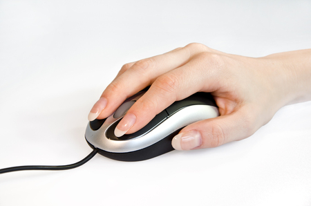 Female hand holding computer mouseの写真素材