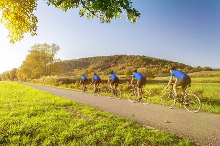 Multiple image of man on a racing bike in scenic autumn landscapeの写真素材