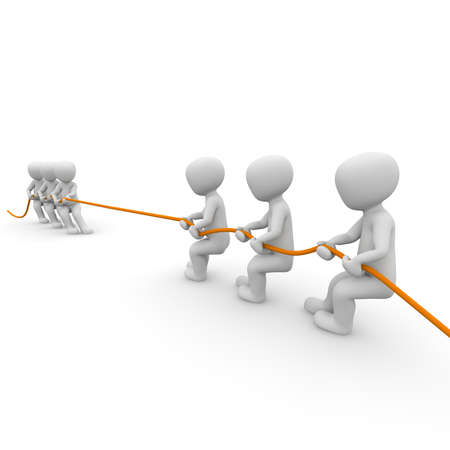 Two groups of people pulling on a rope as long as opposed to a group falls.の写真素材