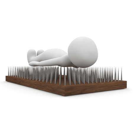 A fakir lies on a nailsboard.の写真素材