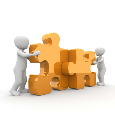 The two characters move two large puzzle pieces together.の写真素材
