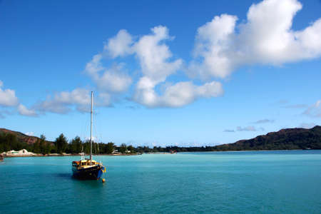 Sailing boat in turquoise blue water in the Seychellesの写真素材