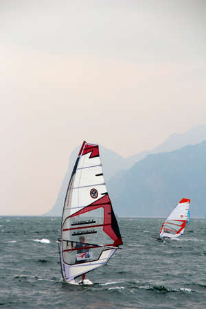 Windsurfer in front of mountains on Lake Garda at high speedのeditorial素材