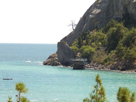 rocks in the sea, sunny, lonely pine, spruce on a rock, mysterious, romanticの写真素材