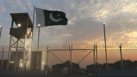 National flag of Pakistan above military base at sunsetの写真素材