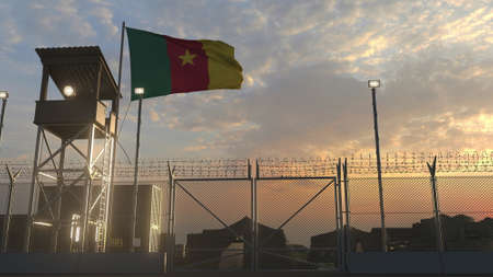 Flying flag of Cameroon above military base in the eveningの写真素材
