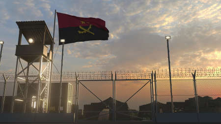 National flag of Angola above military base at sunsetの写真素材