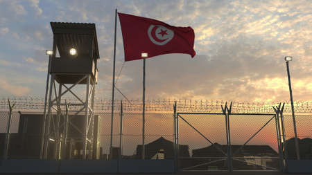 National flag of Tunisia above military base at sunsetの写真素材