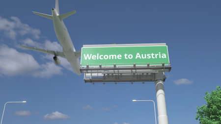 Arriving plane flies over WELCOME TO AUSTRIA road sign 3d renderingの写真素材