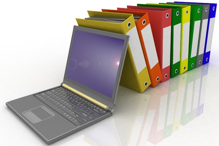Colorful folders next to a modern laptopの写真素材