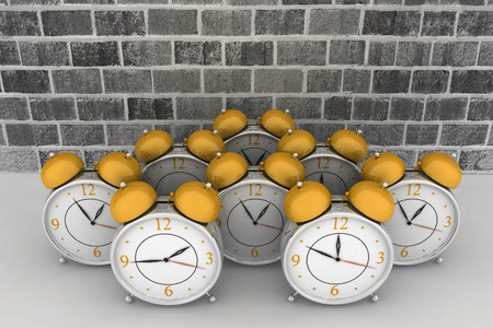 3d brick wall with alarm clocksの写真素材