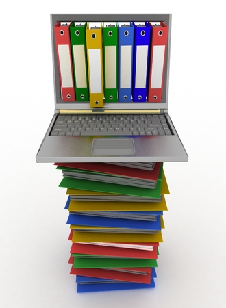 Colorful folders next to a modern laptopの写真素材
