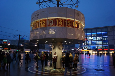 Berlin, Germany: people gathered around the Urania World Clock in Alexanderplatz, by nightのeditorial素材