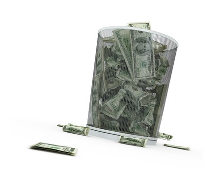 Garbage basket of complete money on a white backgroundの写真素材