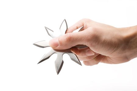shuriken in a hand on a white backgroundの写真素材