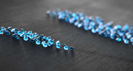 Blue diamond sapphire with group of diamonds background selective focus , 3d illustration.