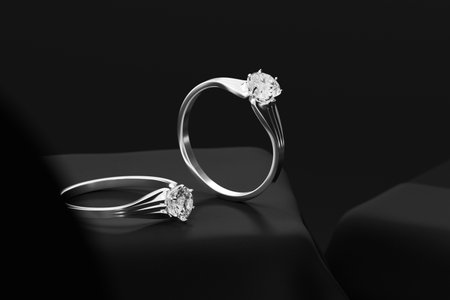 Silver Couple Diamond rings on Black background 3d rendering Soft focusの写真素材