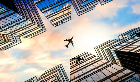 Jet plane plying in business district area, office buildings - 3D illustrationの写真素材