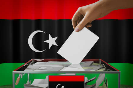 Libya flag, hand dropping ballot card into a box - voting, election concept - 3D illustrationの写真素材