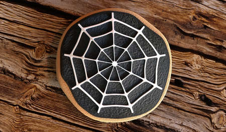 Halloween spiderweb cookie on wooden background - 3D illustrationの写真素材